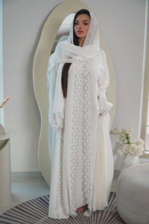 The Abaya Jenna 3-Piece Set is a luxurious and sophisticated ensemble designed for women who seek elegance, refinement, and premium quality. Crafted in luminous off-white ivory, this set includes a majestic abaya, a matching inner dress, and a lightweight chiffon scarf for a perfectly coordinated look.